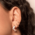 Small ball shaped gold fill huggies in a stack