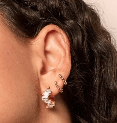 Small ball shaped gold fill huggies in a stack