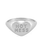 Heart-shaped silver ring with 'HOT MESS' engraving on a white background