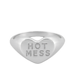 Heart-shaped silver ring with 'HOT MESS' engraving on a white background