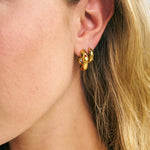 Carnival Hoops in close up photo with Nymph huggies in a stack