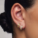 Aars Huggies. Small wavy thick gold Huggies on a model