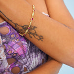 Close up of vintage style textured bracelet and red garnet gemstones