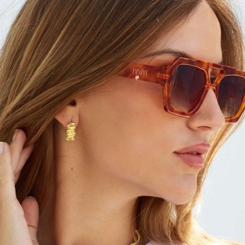 Model in Bixby jewellery earrings