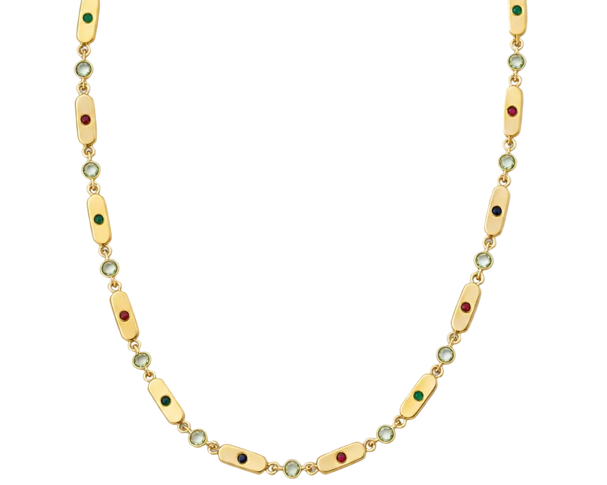 A gold chain necklace featuring elongated oval links with small green and red enamel accents, interspersed with tiny round clear stones, shown against a plain white background.