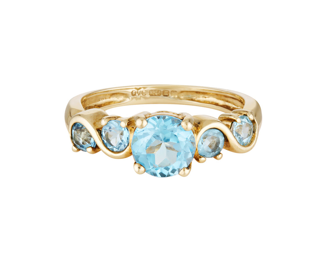 Gold ring with blue gemstones on a white background