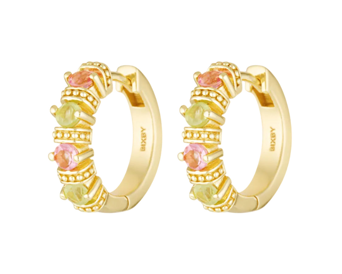 Gold hoop earrings with colorful gemstones on a white background