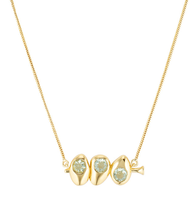 Gold necklace with three green gemstones on a white background
