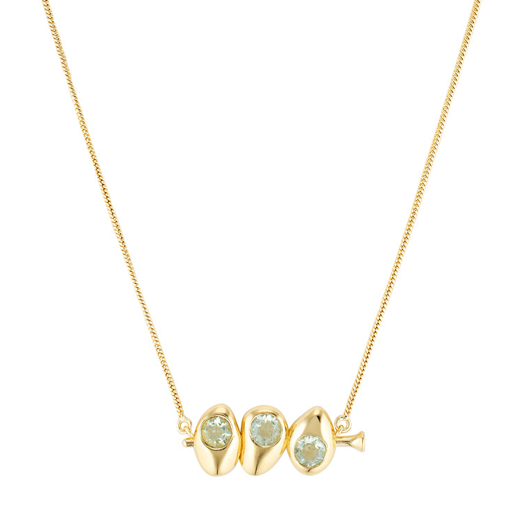 Gold necklace with three green gemstones on a white background