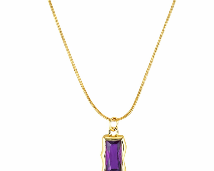 Gold necklace with a purple gemstone pendant on a white background