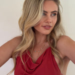 Woman wearing a red top with a plain background