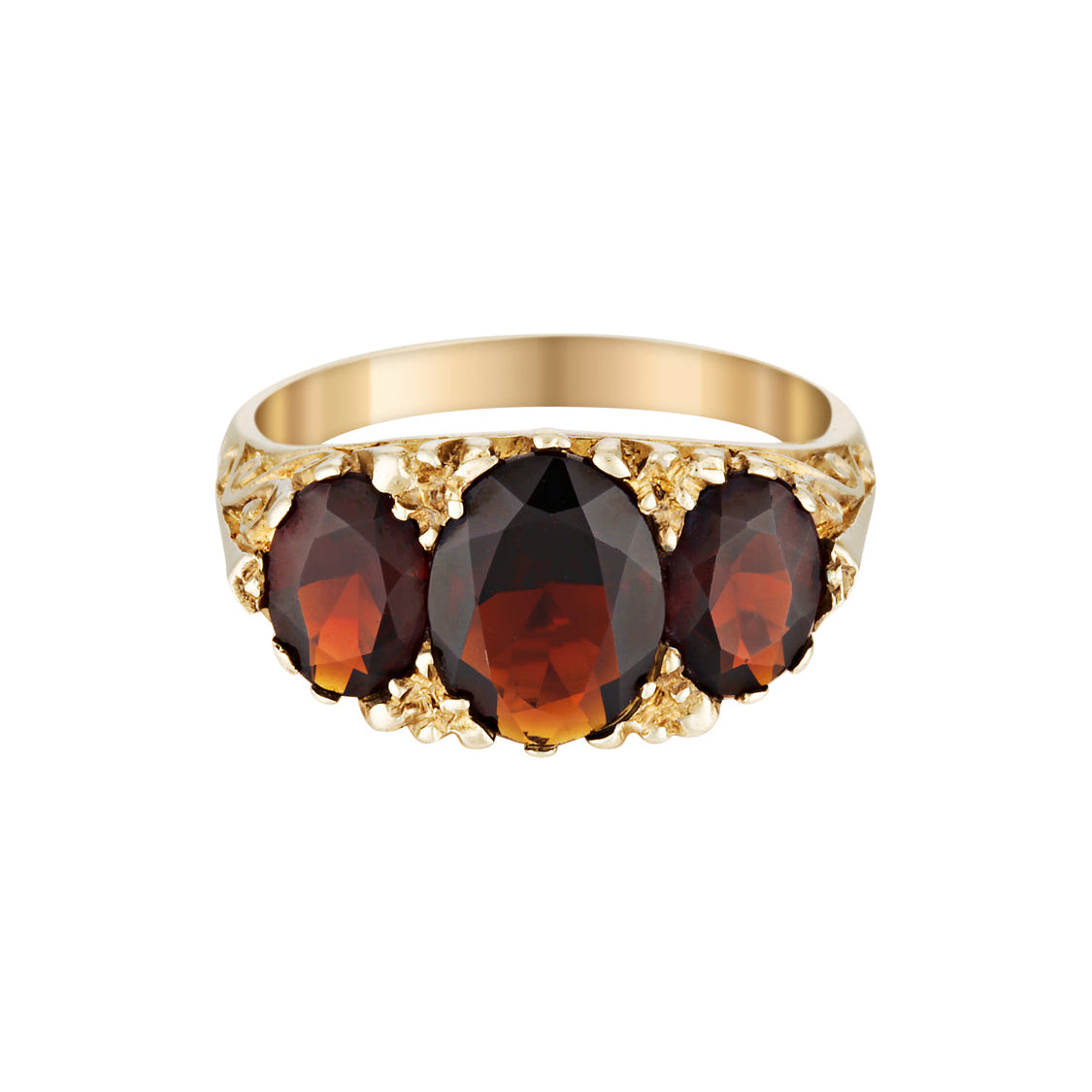 Gold ring with three dark red garnet gemstones on a white background