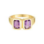 Gold ring with purple gemstones on a white background