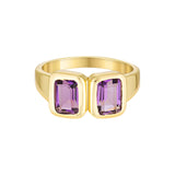 Gold ring with purple gemstones on a white background