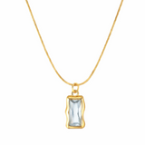 Gold necklace with a rectangular pendant on a white background