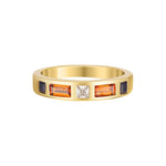 Gold ring with embedded gemstones on a white background