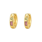 A pair of gold huggie hoop earrings with a rectangular pink gemstone and a round light green gemstone on each earring, set against a light gray background.