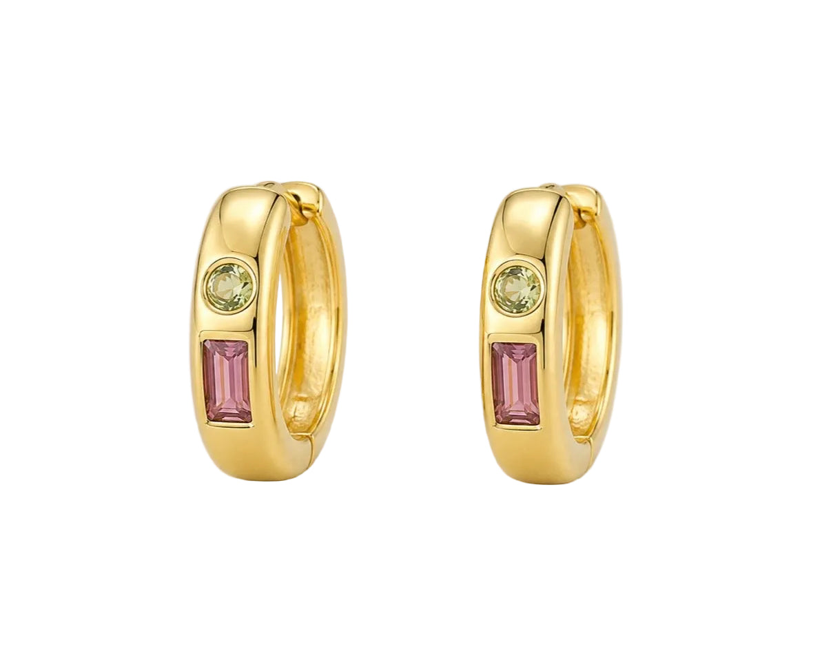 A pair of gold huggie hoop earrings with a rectangular pink gemstone and a round light green gemstone on each earring, set against a light gray background.