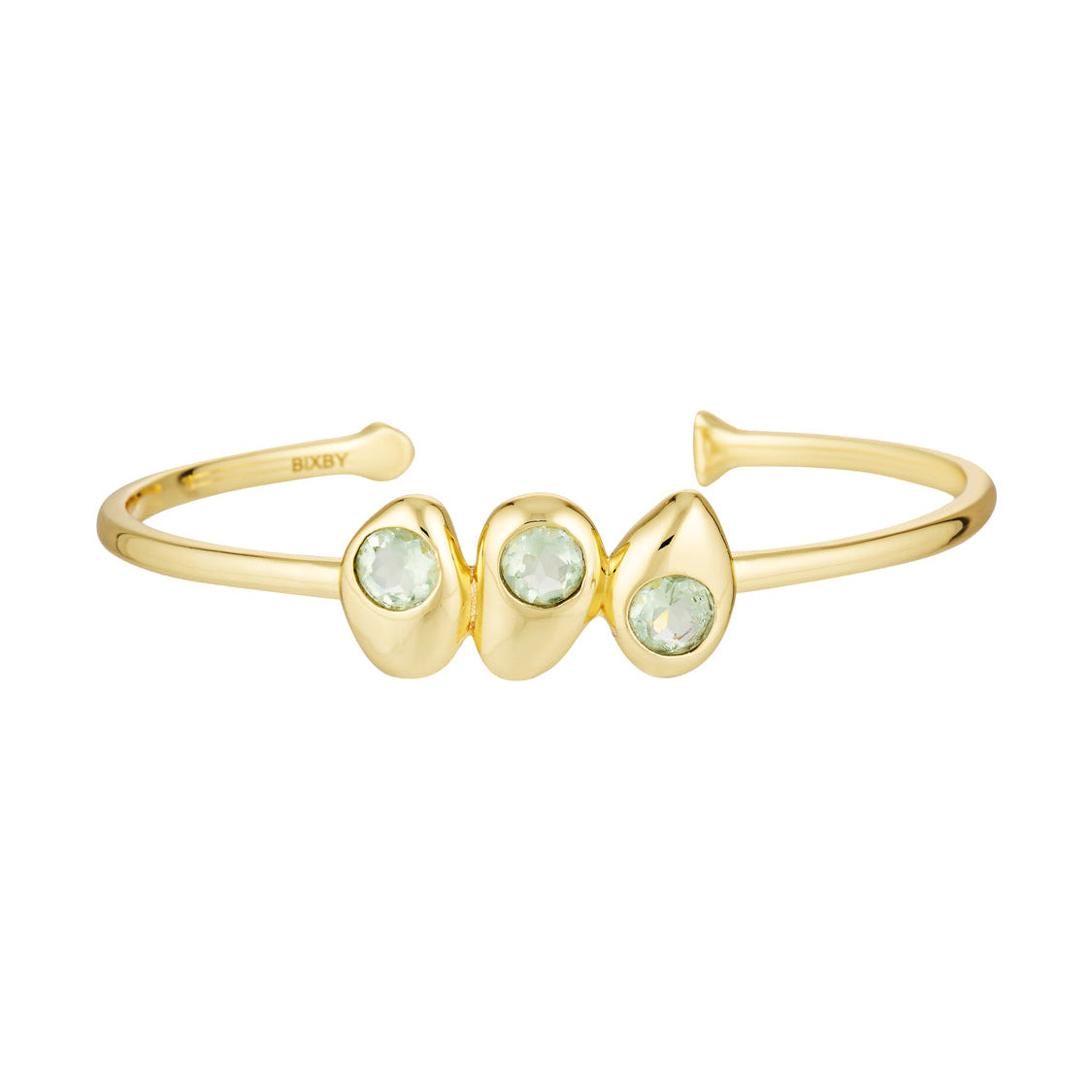 Gold bracelet with three green gemstones on a white background