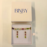 Multicolored gemstone earrings in a Bixby box on a beige background