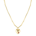 Gold heart-shaped necklace with a red gemstone on a white background