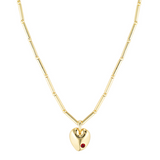 Gold heart-shaped necklace with a red gemstone on a white background