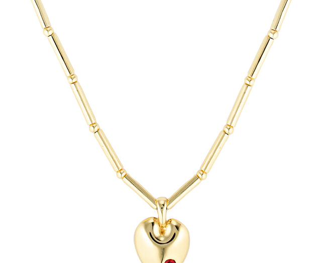 Gold heart-shaped necklace with a red gemstone on a white background