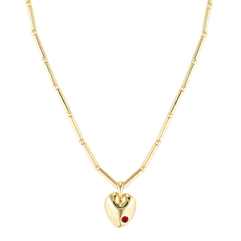 Gold heart-shaped necklace with a red gemstone on a white background