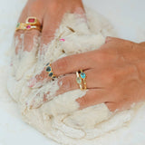 Close-up of hands with rings on a white background
