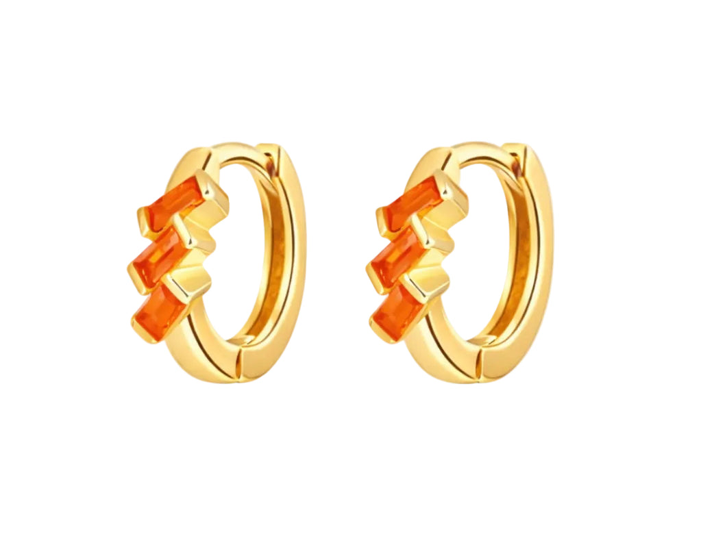 Gold hoop earrings with orange stones on a white background