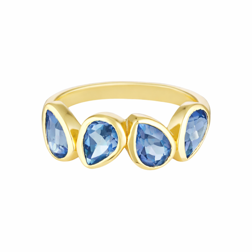 Gold ring with blue teardrop-shaped gemstones on a white background