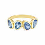 Gold ring with blue teardrop-shaped gemstones on a white background