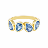 Gold ring with blue teardrop-shaped gemstones on a white background