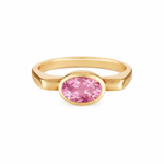 Gold ring with a pink gemstone on a white background