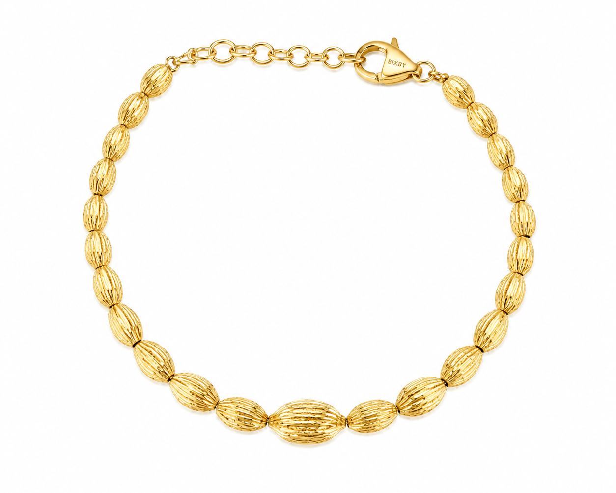 A gold beaded bracelet with textured, ribbed oval beads and a lobster clasp, displayed on a clean white background.