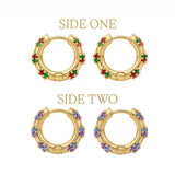Two pairs of gold huggie hoop earrings with multicolor gemstone accents, labeled 'SIDE ONE' and 'SIDE TWO' on a white background. The top pair features green and red stones, and the bottom pair features purple and blue stones.