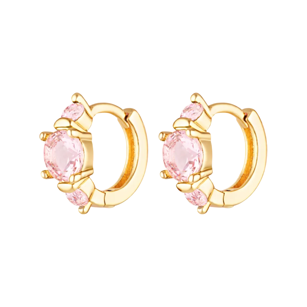 Gold hoop earrings with pink gemstones on a white background