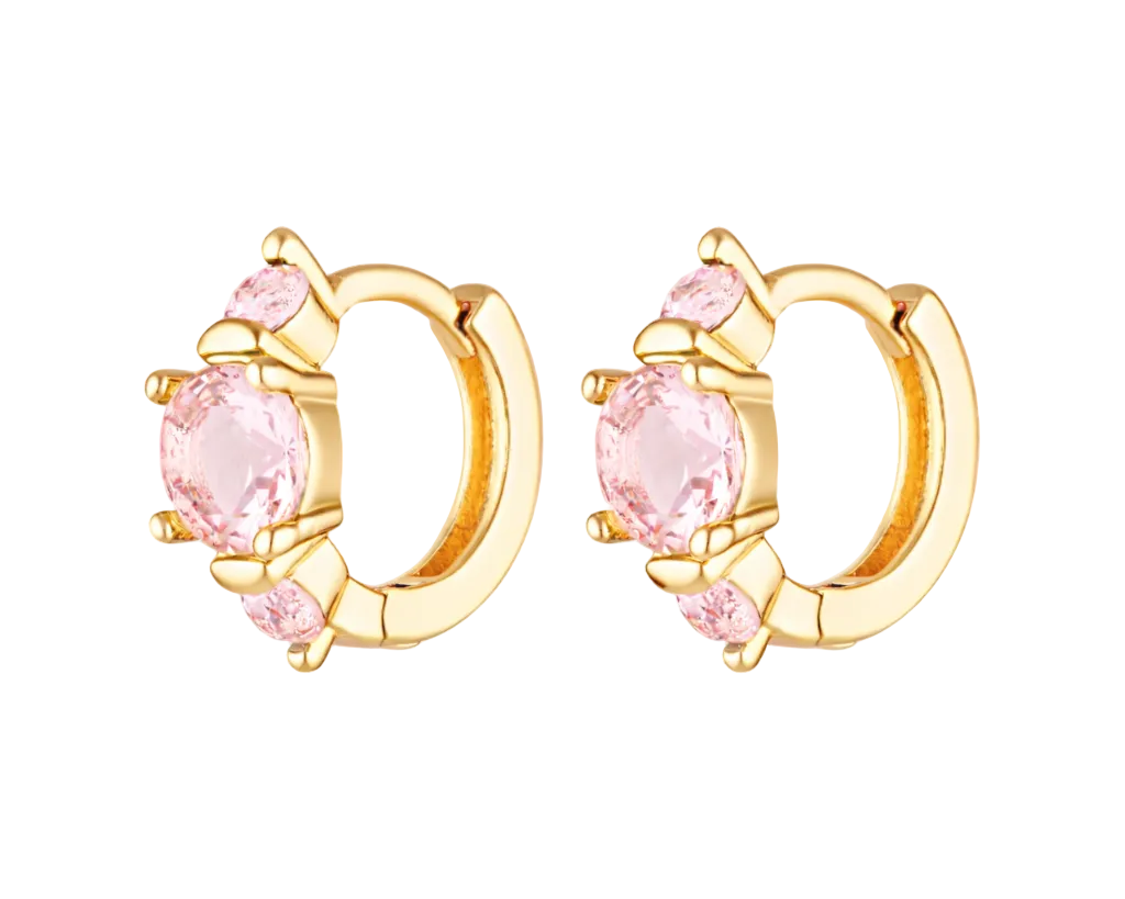 Gold hoop earrings with pink gemstones on a white background