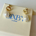Pearl drop organic gold earrings on Bixby packaging