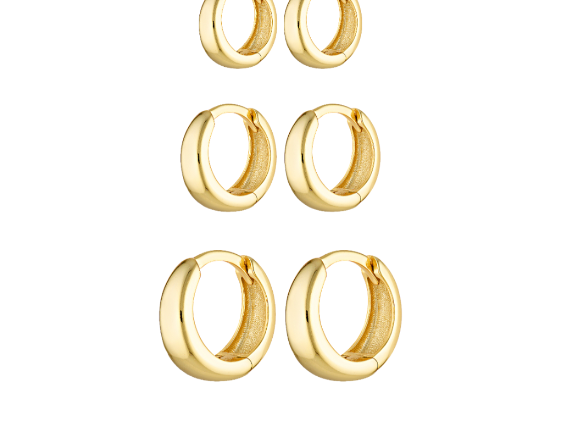 Set of gold hoop earrings on a white background