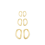 Set of gold hoop earrings on a white background