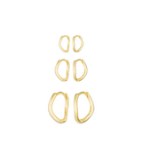Set of gold hoop earrings on a white background