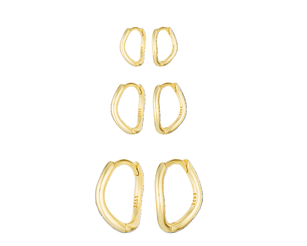 Set of gold hoop earrings on a white background