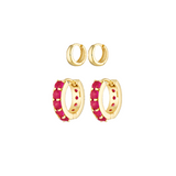 Gold hoop earrings with pink accents on a white background
