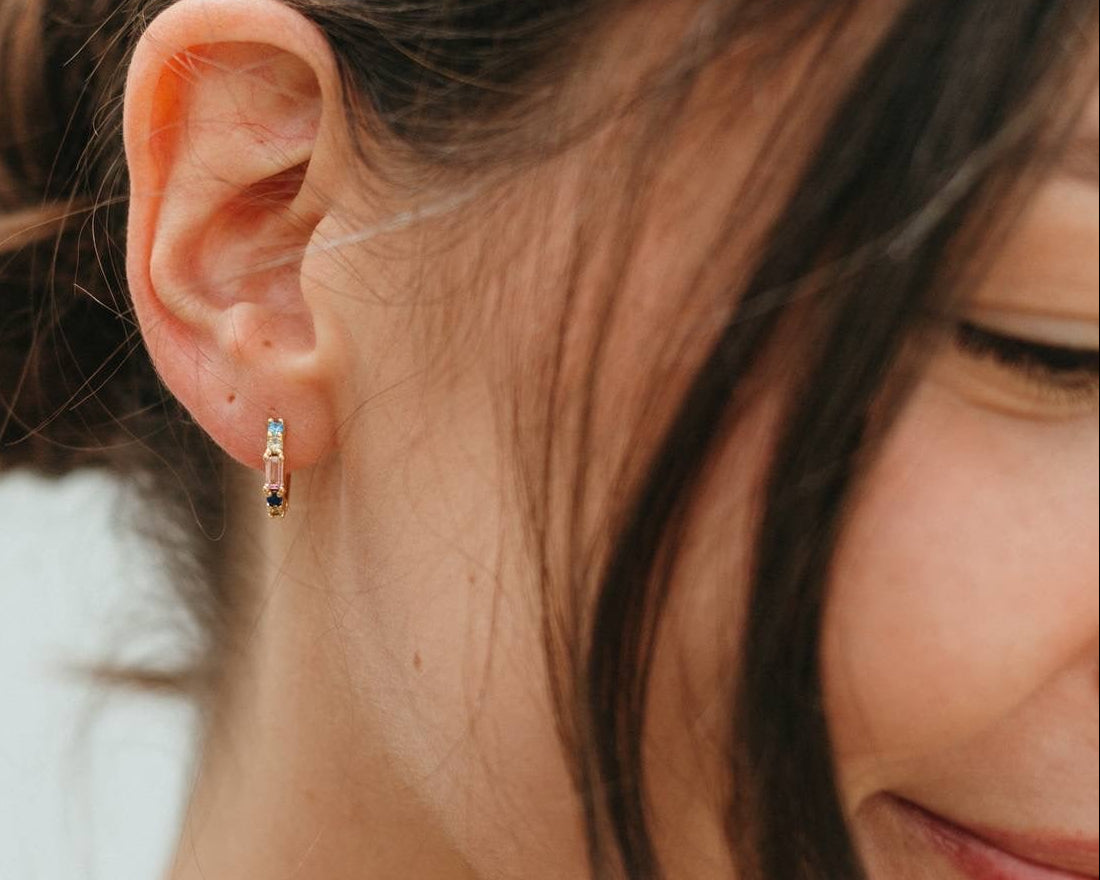 Close-up of a person wearing a small earring with a blurred background
