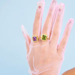 The two Dauphine cocktail rings in Amethyst and Peridot on a gloved hand 