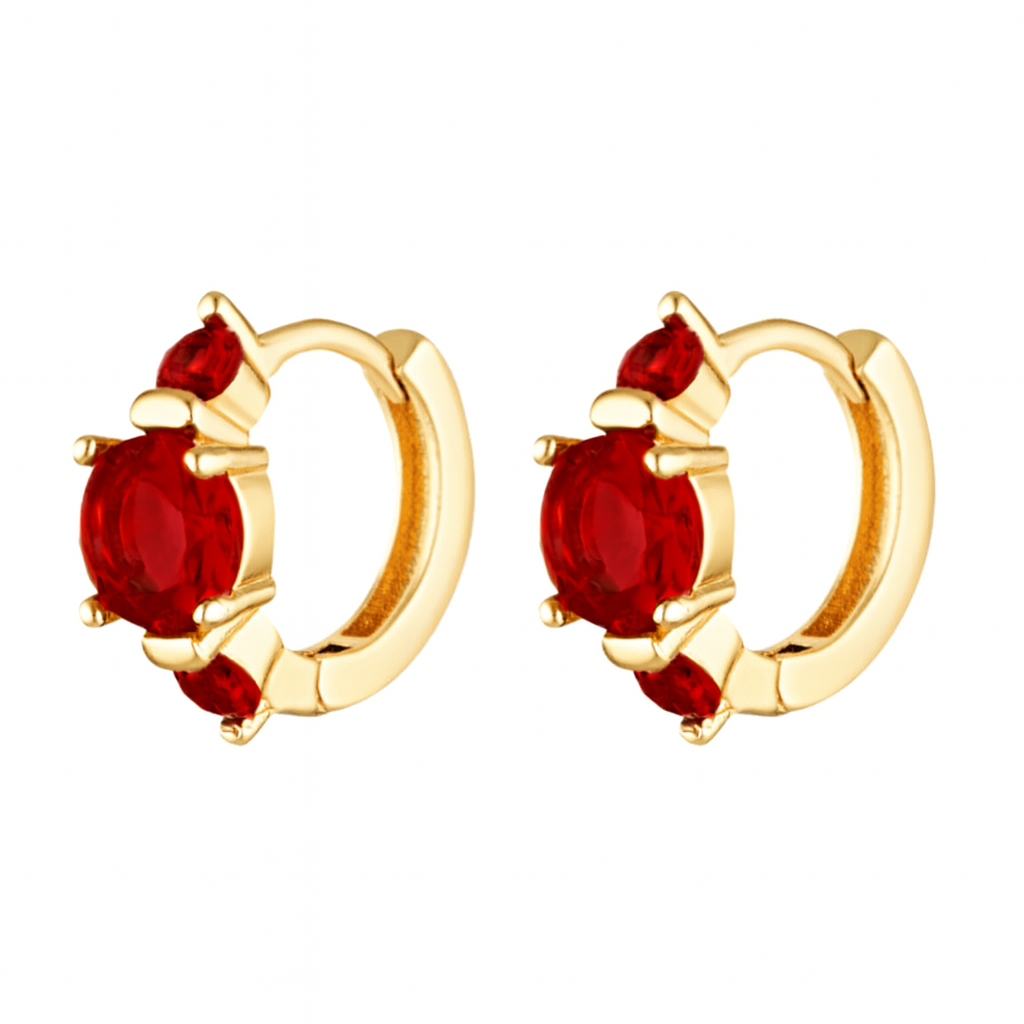 Gold hoop earrings with red gemstones on a white background