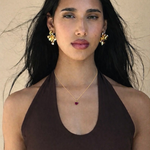 Model in small dainty red heart pendant