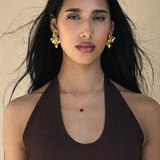Model in small dainty red heart pendant