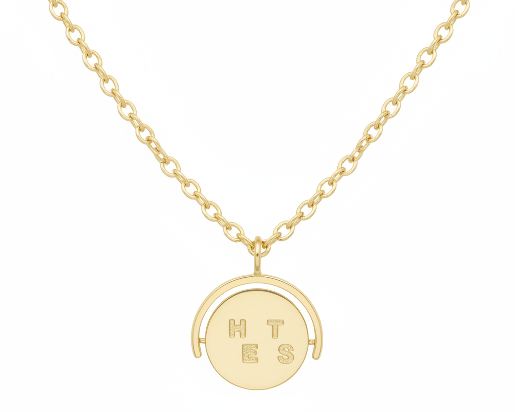 Gold necklace with a round pendant on a white background